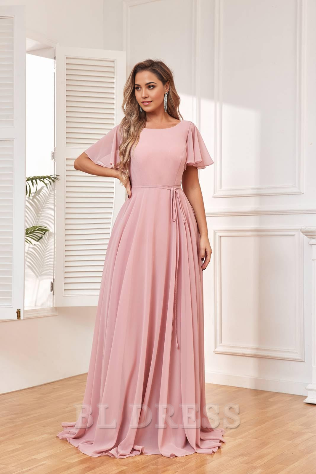 Elegant A-Line chiffon dress with bateau neckline and flutter sleeves.