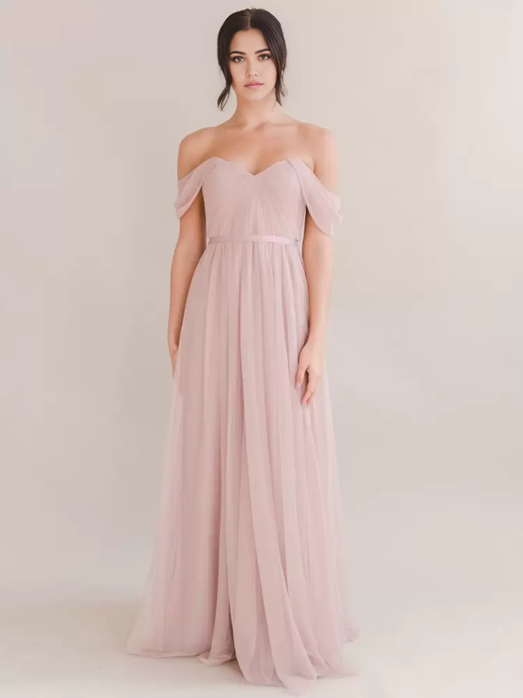Woman wearing an elegant A-line bateau neck chiffon floor-length formal gown.