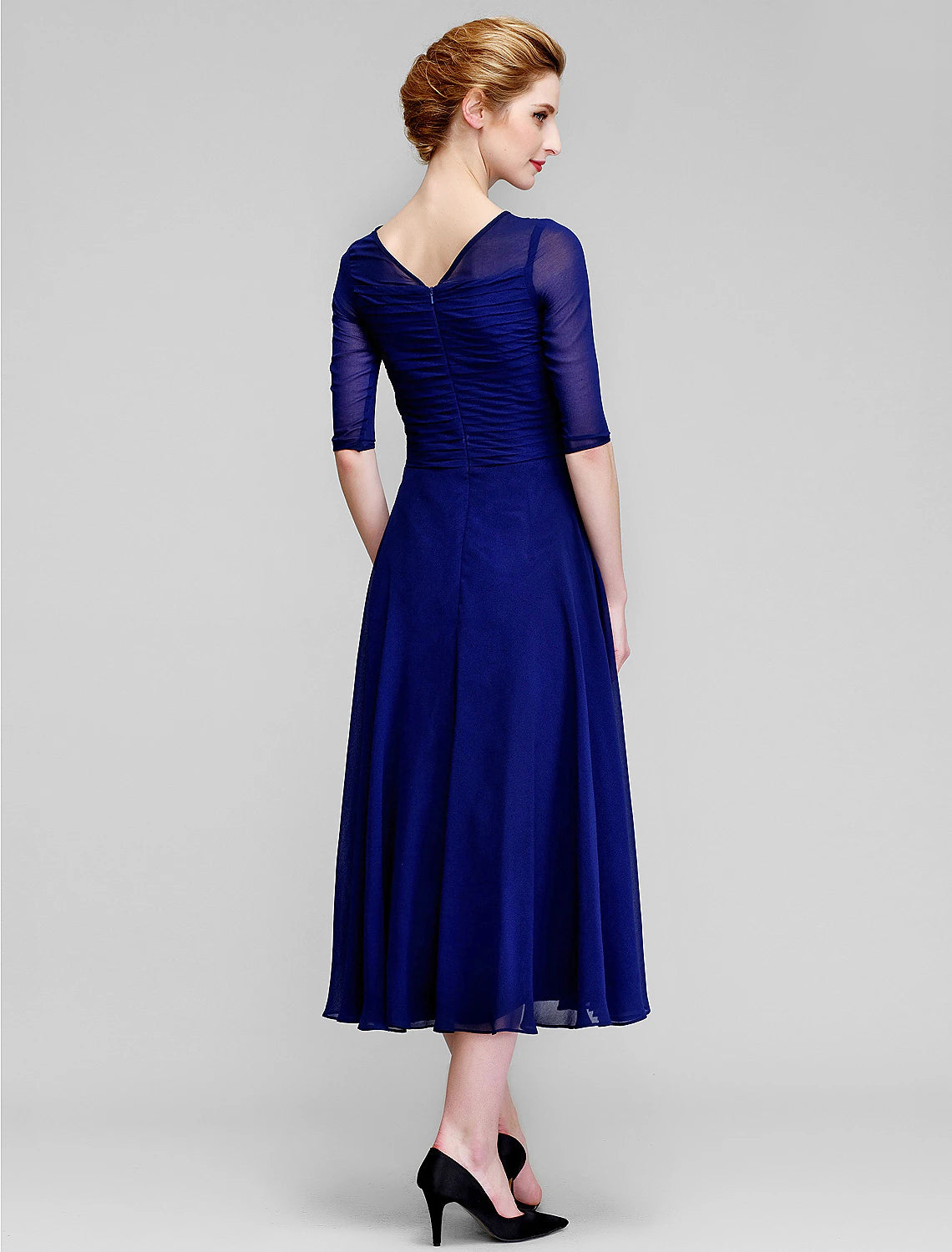 Detail of the bateau neckline and half sleeve on the formal dress.