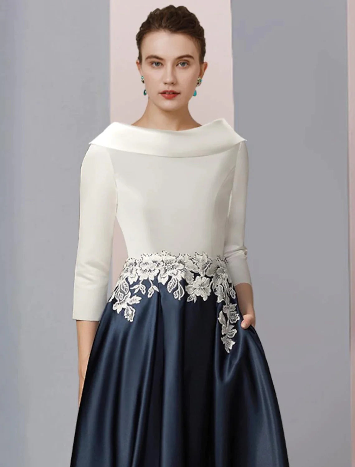 Tea length satin lace dress with pleats and appliques.