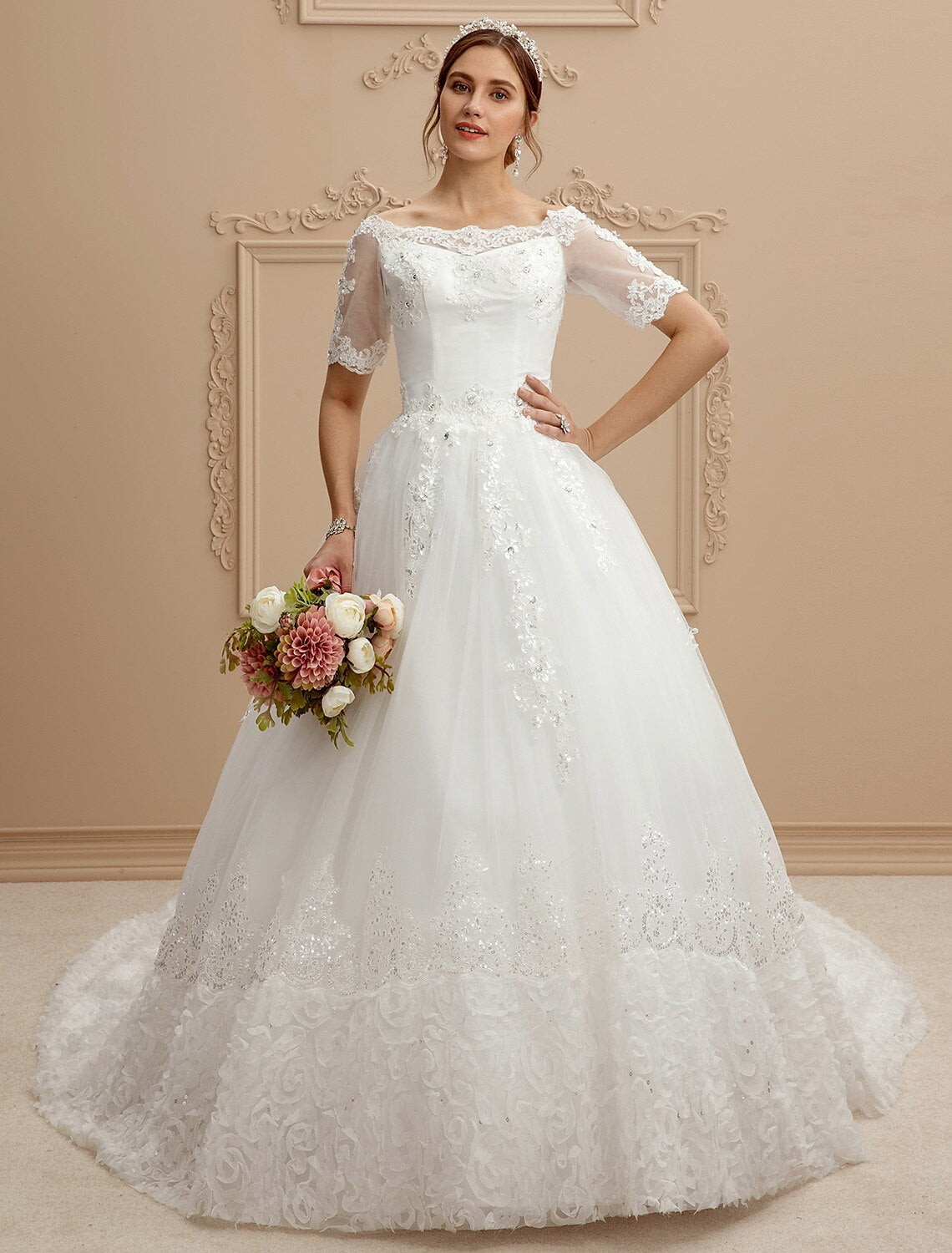 Front view of an A-Line wedding dress with a bateau neck and lace bodice.