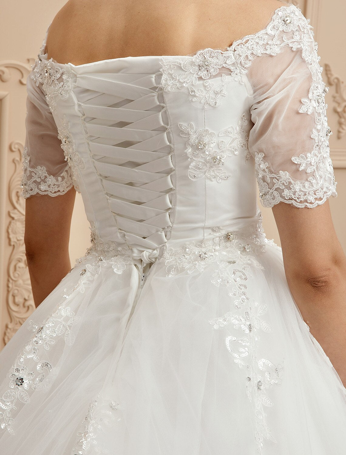 Close-up of the delicate lace details on the bodice of the wedding dress.