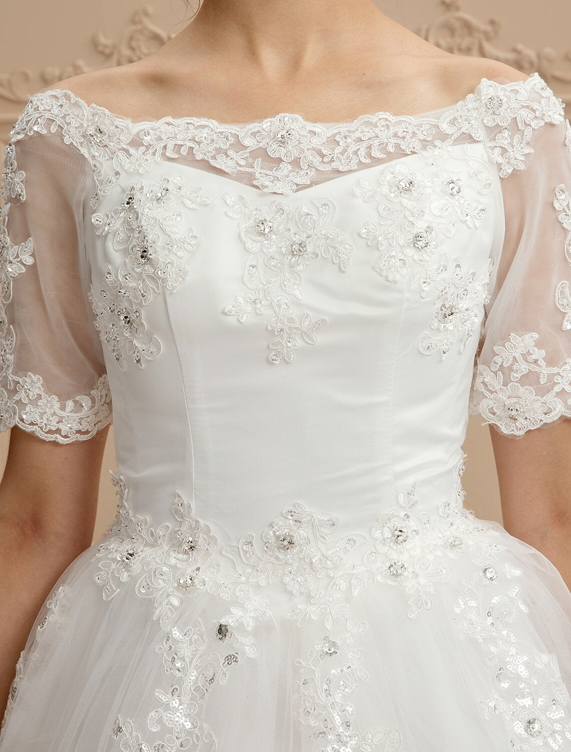 Back view of an A-Line wedding dress with a long cathedral train and lace accents.
