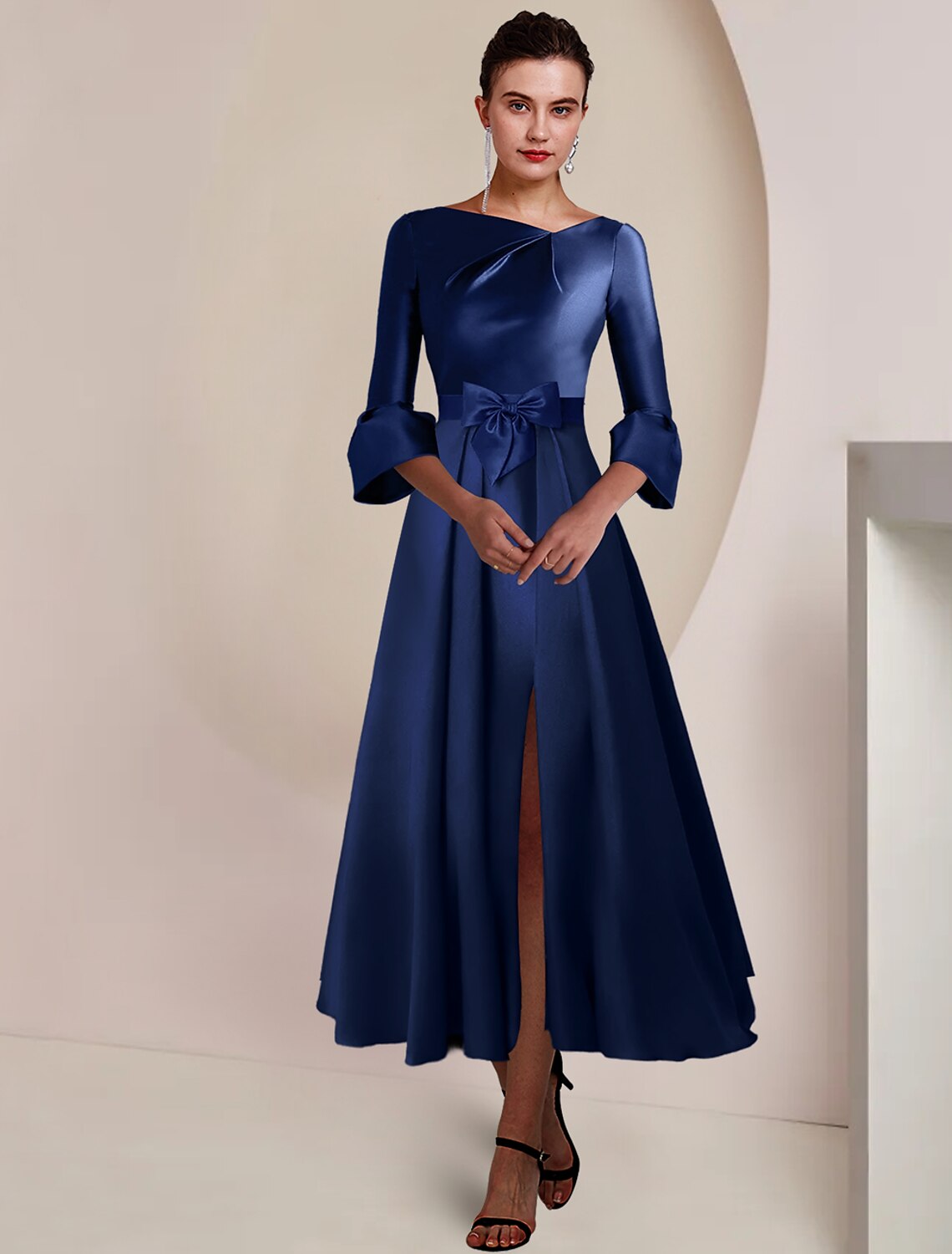 Elegant A-Line Mother of the Bride dress with bateau neck and tea length silhouette.