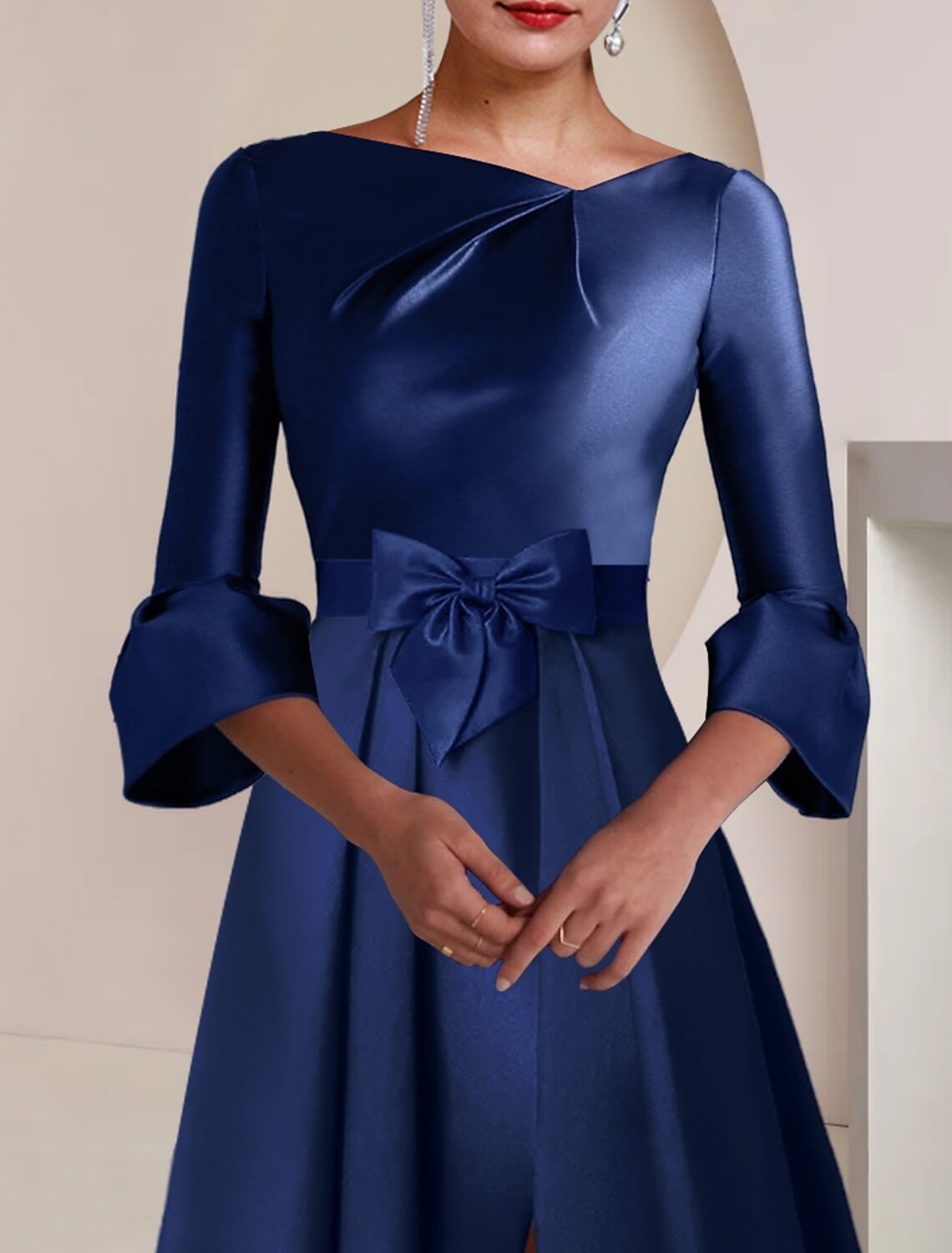 Close-up of the bateau neckline and satin fabric of the elegant dress.