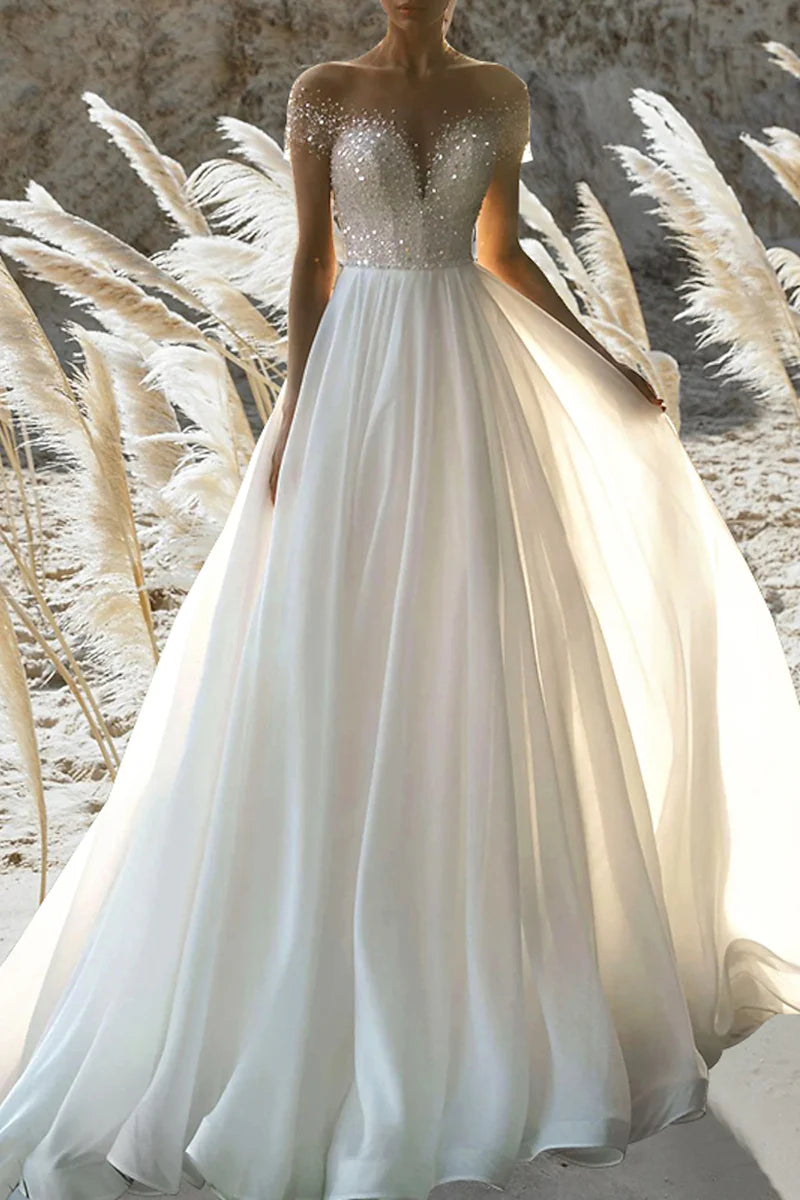 A-line beach wedding dress with short sleeves and beading, front view.