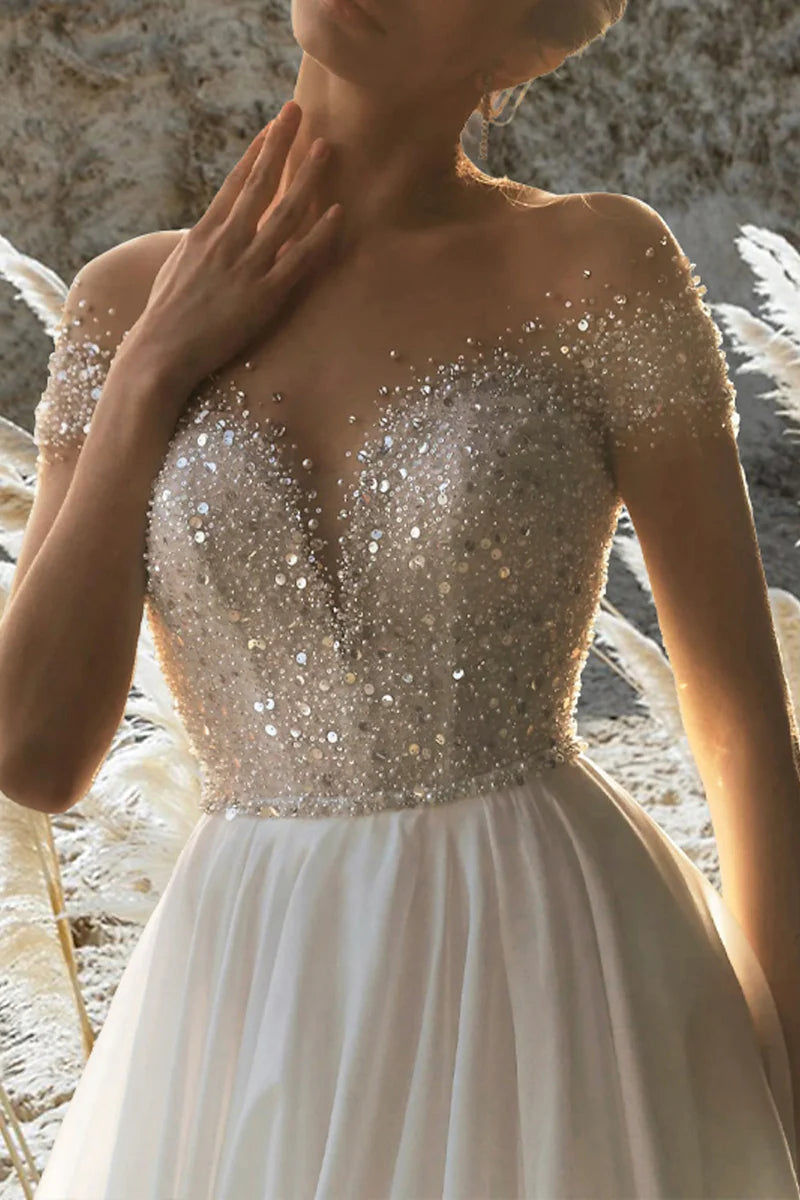 Side profile of an elegant A-line beach formal wedding gown.