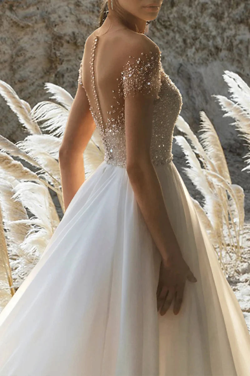 Close-up of the beading detail on a short sleeve A-line wedding dress.