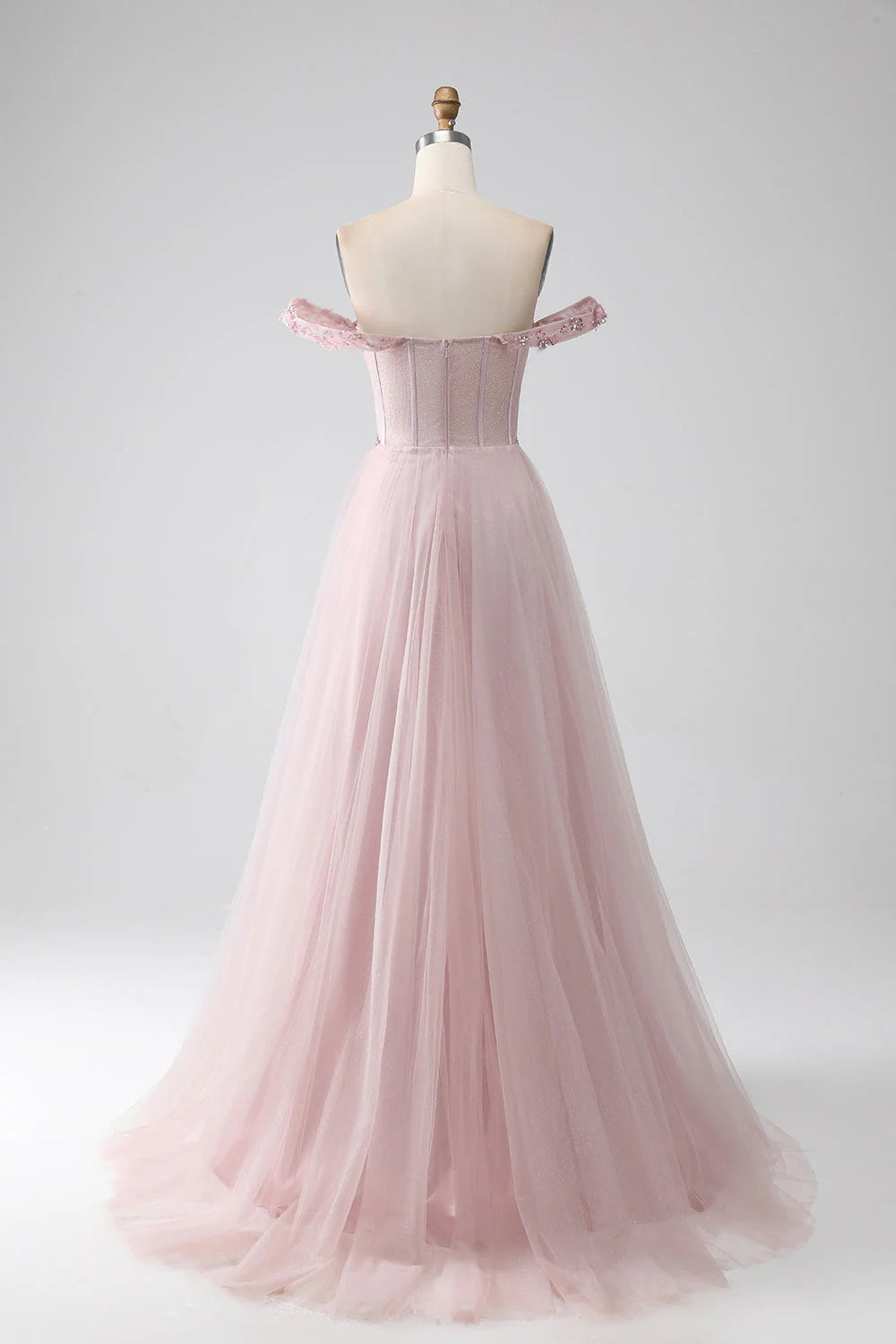 Back view of the blush A-line prom gown, showcasing intricate beading.