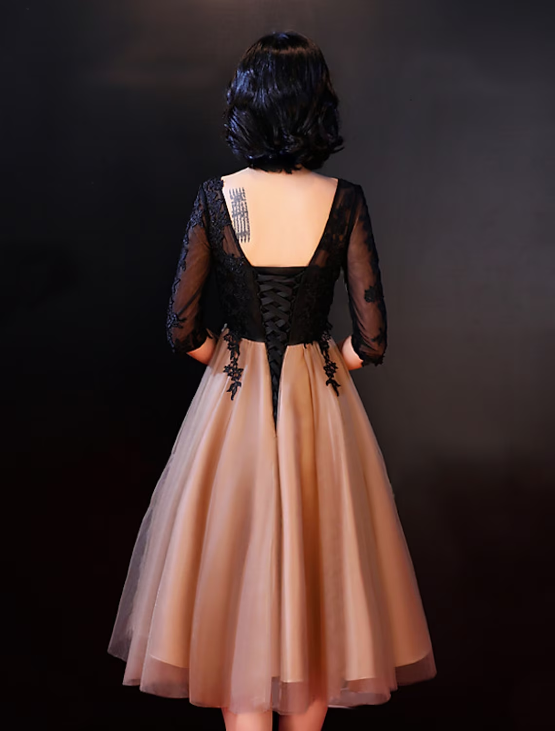 Back view of the A-Line lace dress showing backless design.