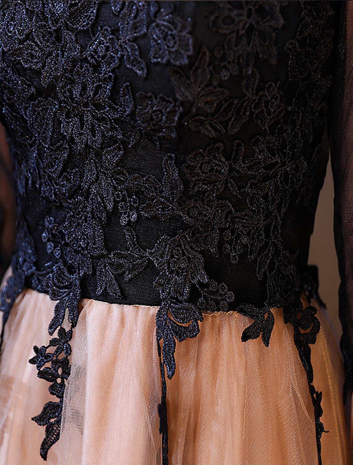 Close-up of delicate lace and half sleeve detail on the cocktail dress.