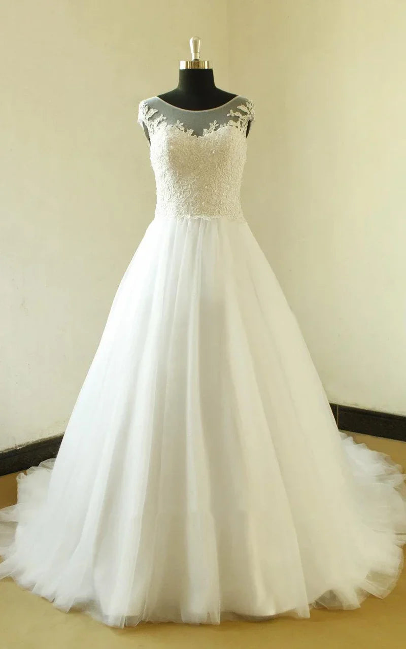 Elegant A-line tulle wedding dress with long sleeves and boat neck.