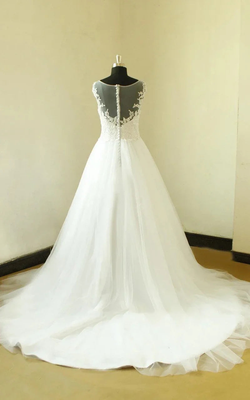 Side view of a flowy A-line tulle wedding dress with long sleeves.