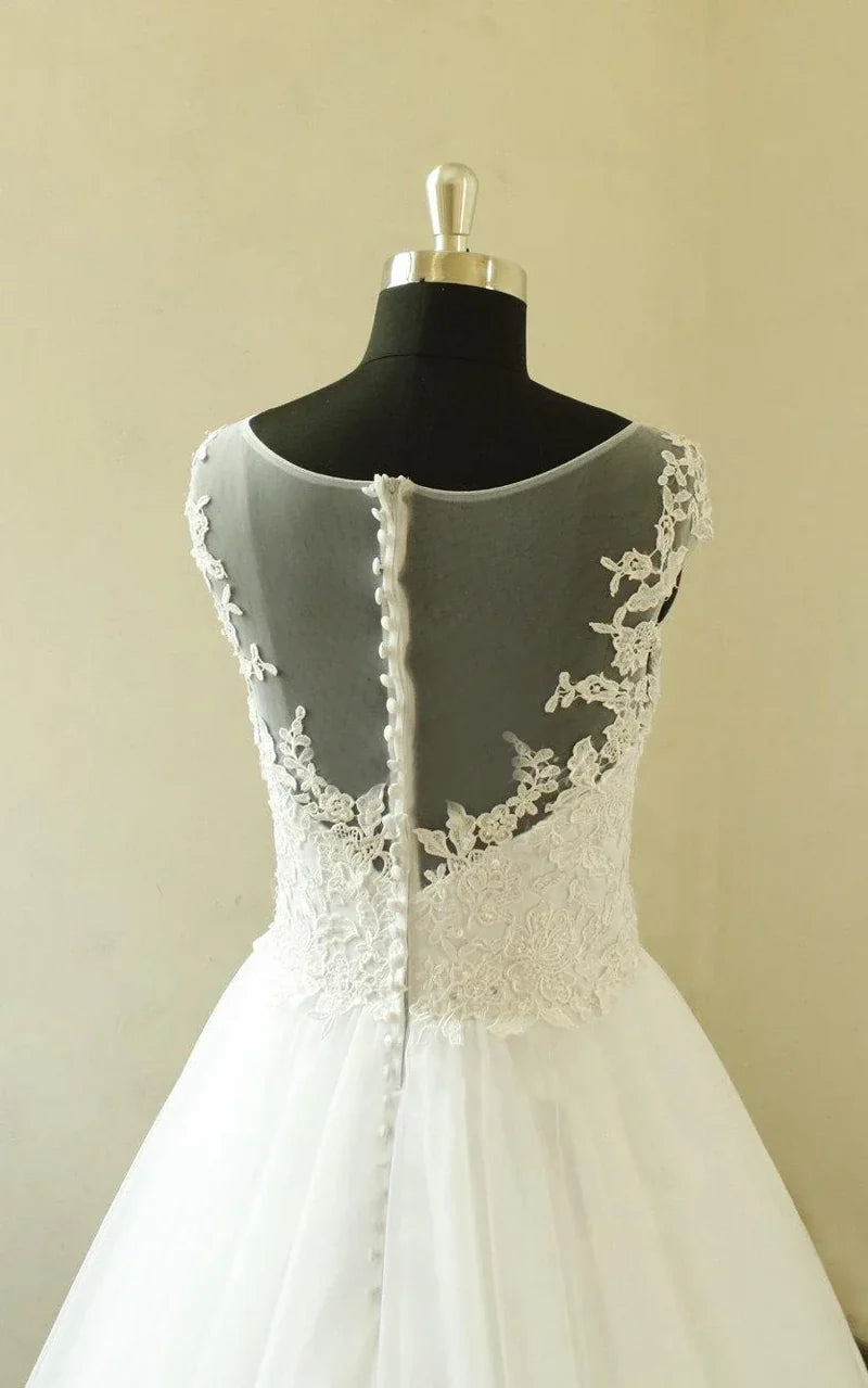 Back view of a modest A-line wedding gown made of delicate tulle.