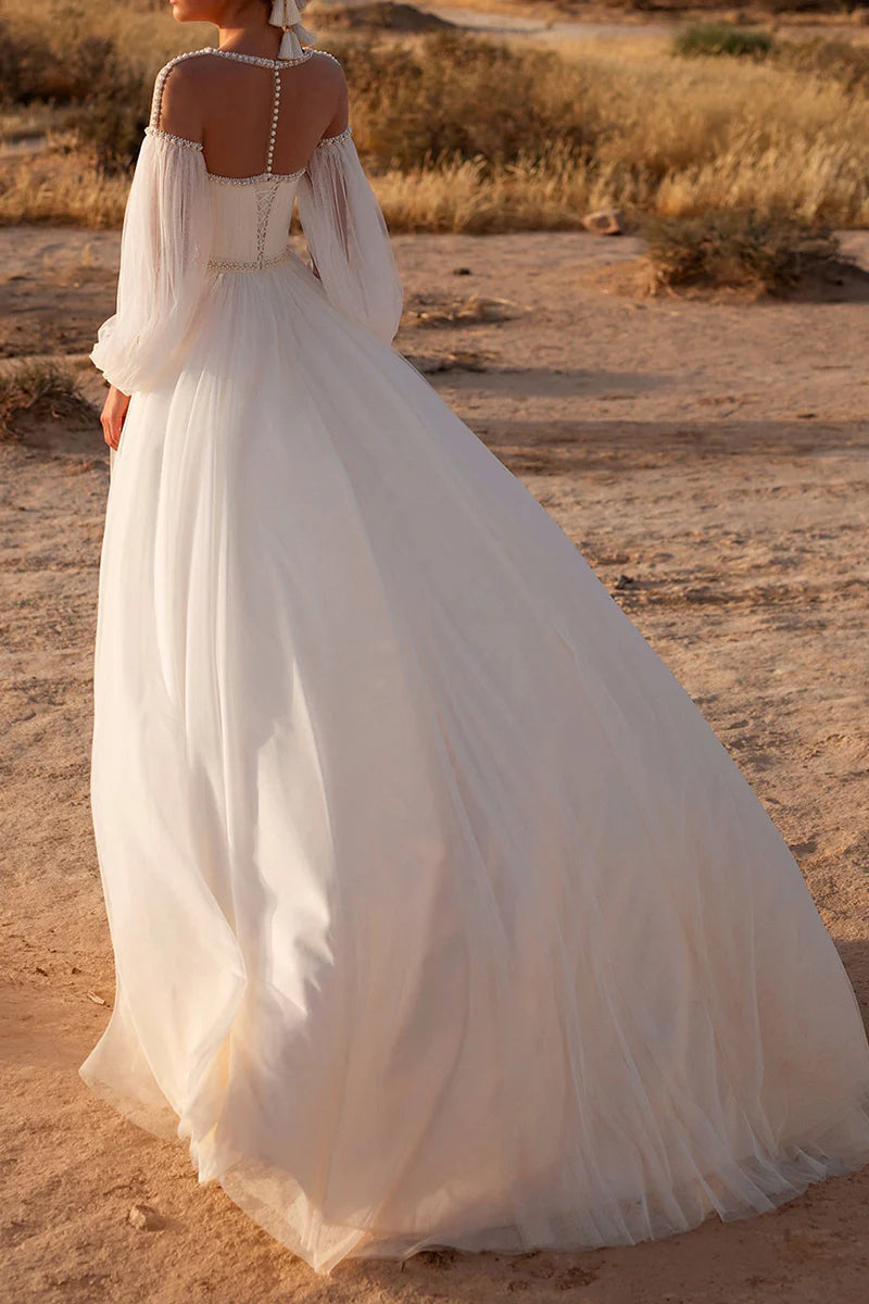 Close-up of the boat neckline and delicate pearl embellishments on the wedding dress.