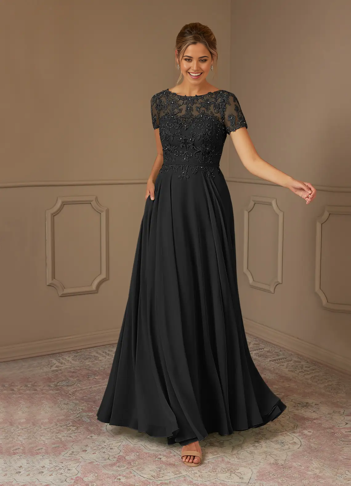 Full length view of a black A-line sequin chiffon dress with a boatneck.