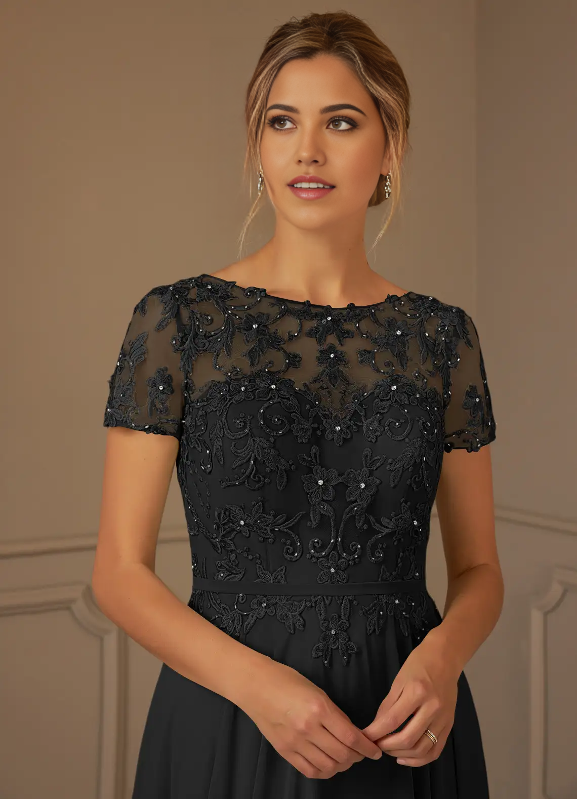 Close-up of the sequin and chiffon fabric detail on the black dress.