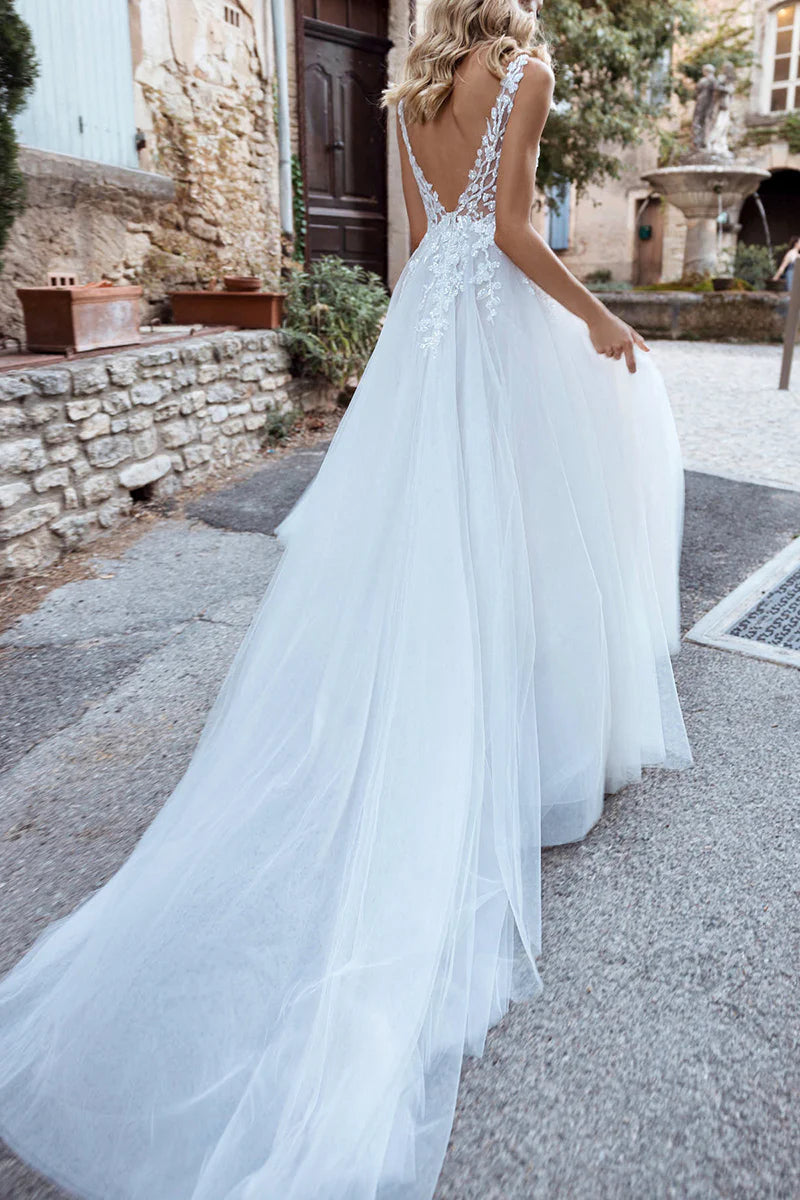 Close-up of the lace appliques on the V-neck of the wedding dress.