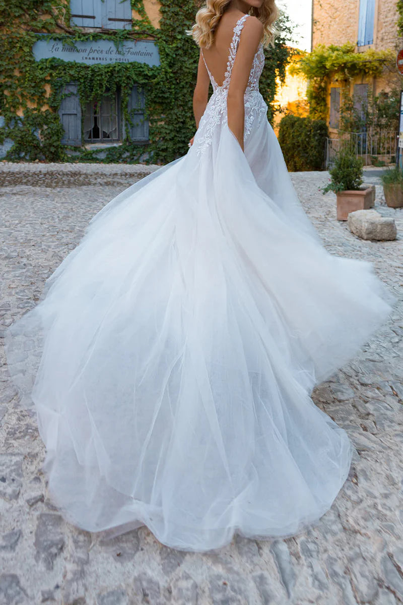 Back view of the A-line boho wedding dress, showing its flowing skirt.