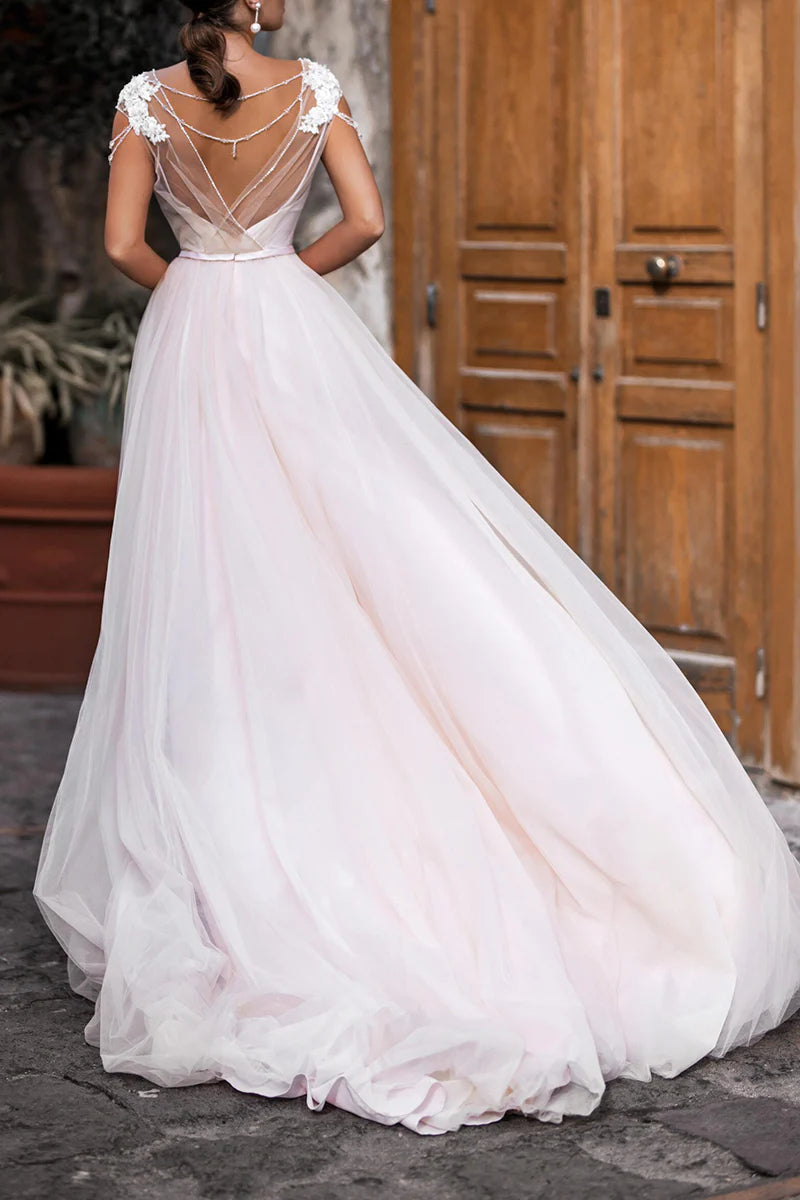 Back view of an A-line boho wedding dress featuring a boat neckline and intricate appliques.