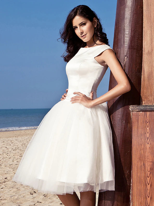 Full length view of the white satin A-line dress with elegant draping.