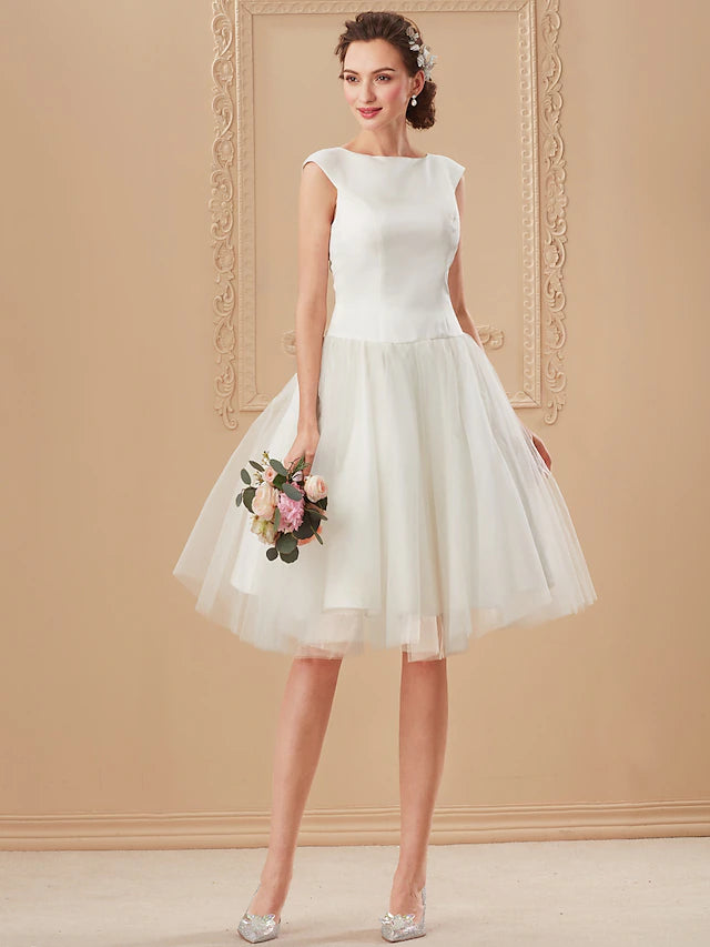 Detail of the luxurious satin fabric and subtle draping on the white wedding dress.