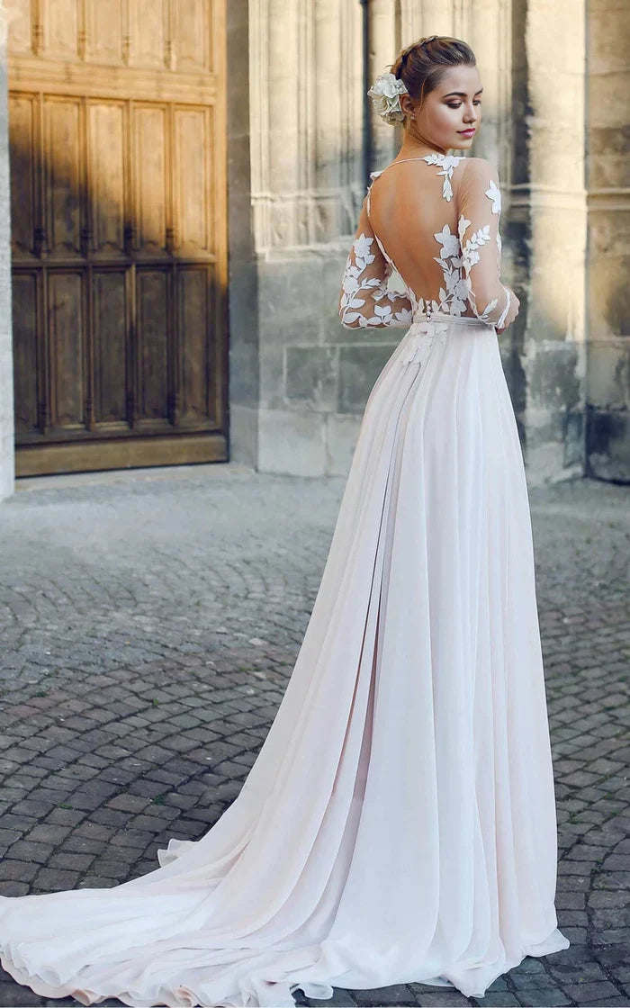 Close-up of the delicate appliques and bateau illusion neckline on the wedding dress.