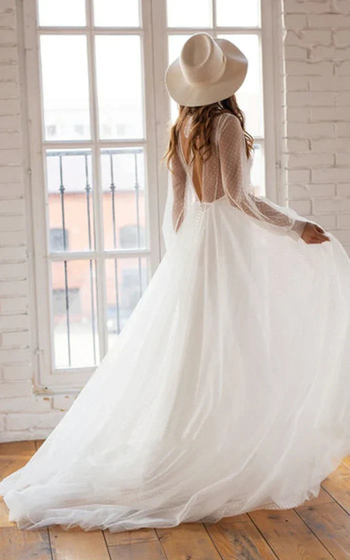 Bride wearing a flowing A-Line chiffon gown with delicate beading.