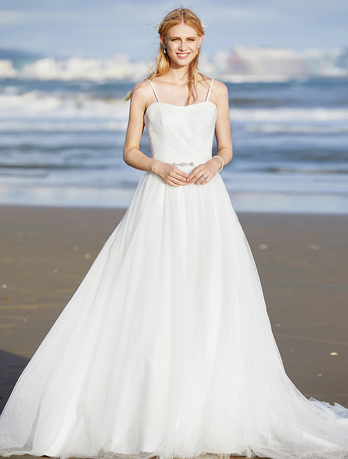 Elegant A-Line chiffon beach wedding dress with spaghetti straps.