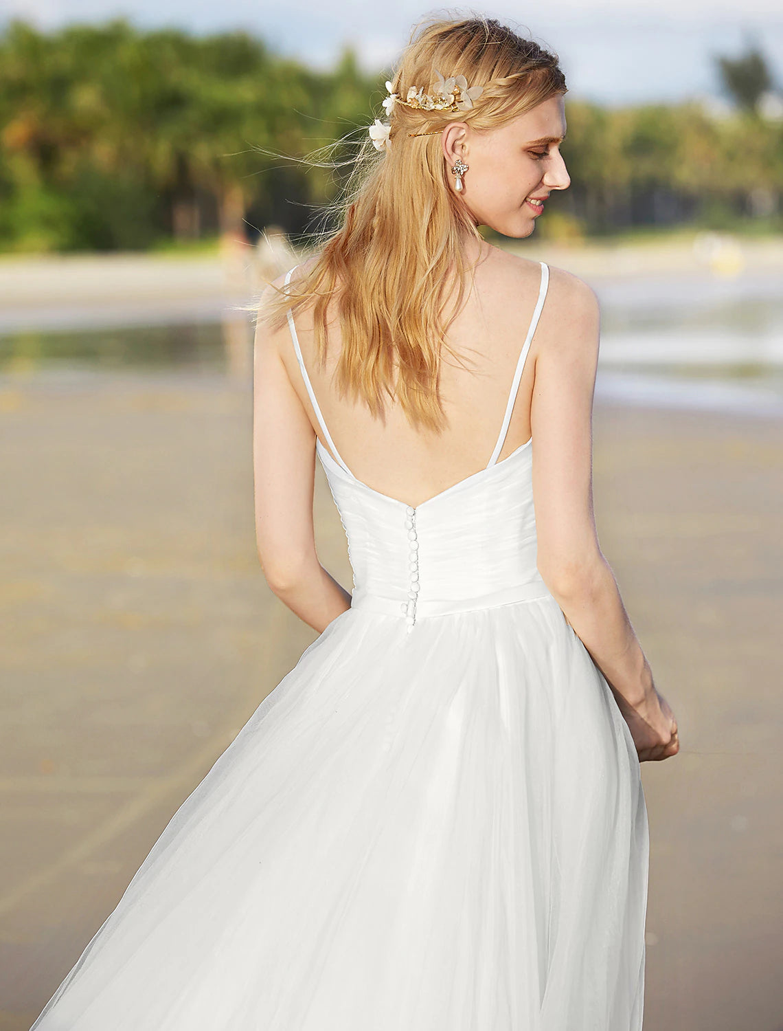 Side view of spaghetti strap chiffon wedding dress.