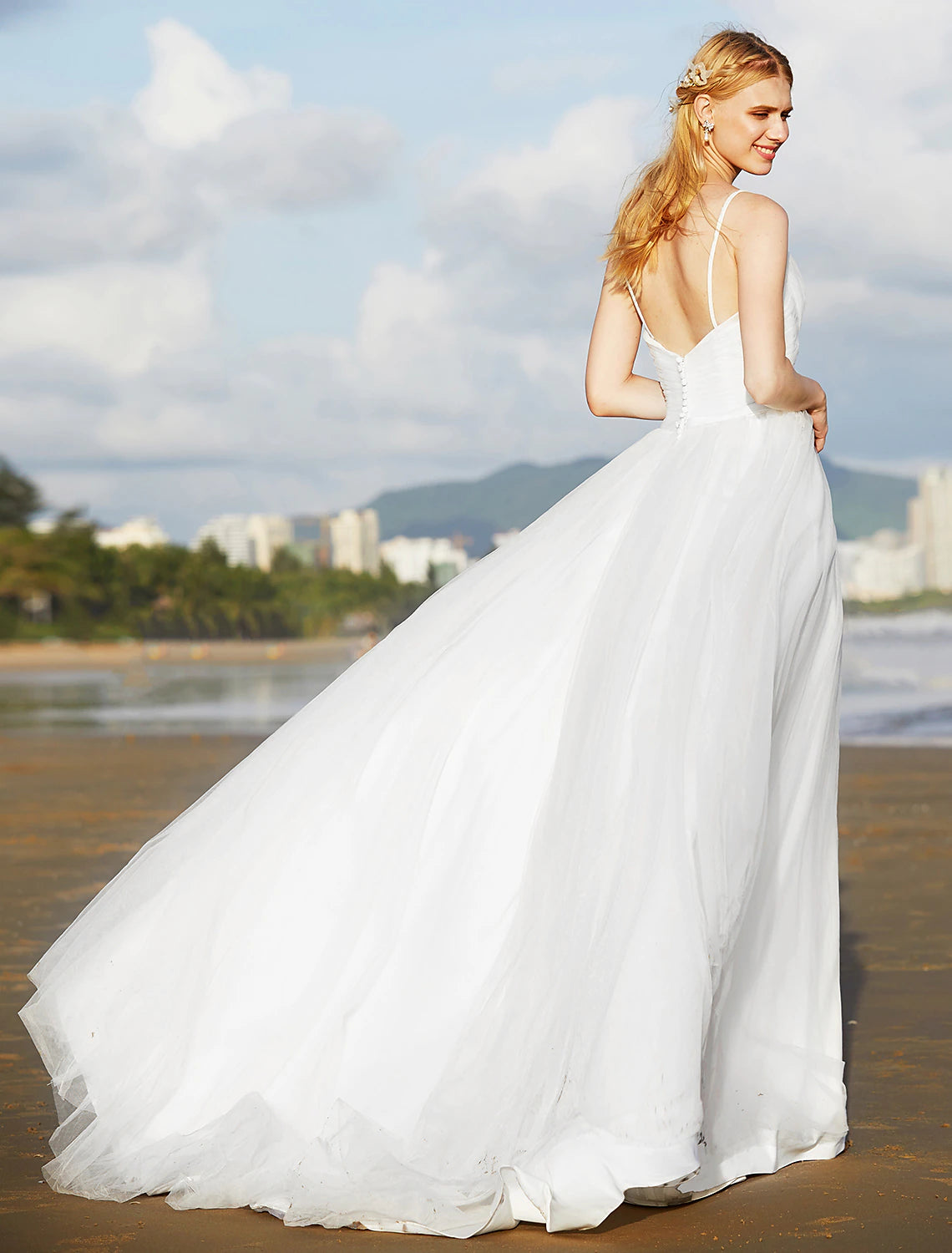 Full length view of the sleeveless chiffon wedding dress.