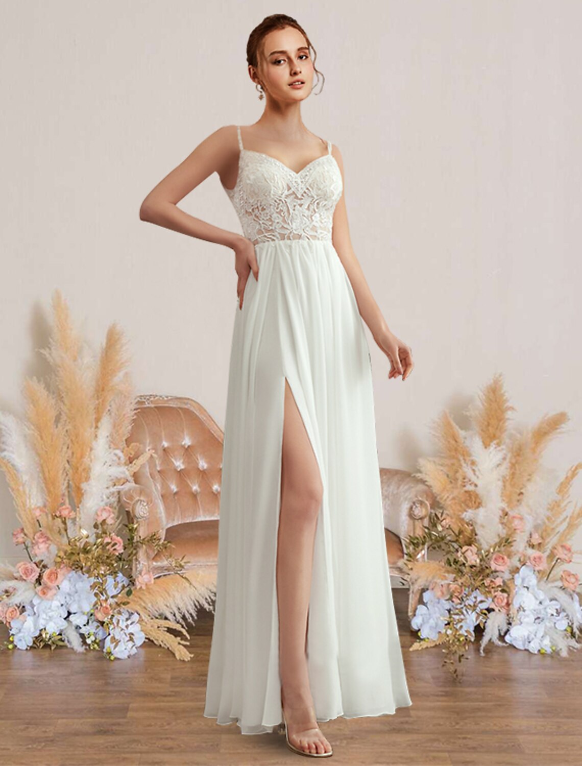 Elegant A-line chiffon beach wedding dress with sweetheart V-neck, spaghetti straps, pleats, and appliques.