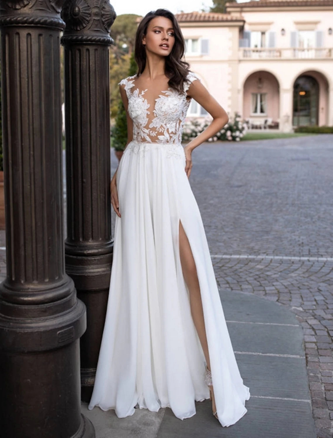 Elegant A-line chiffon wedding dress with cap sleeves and illusion neckline.