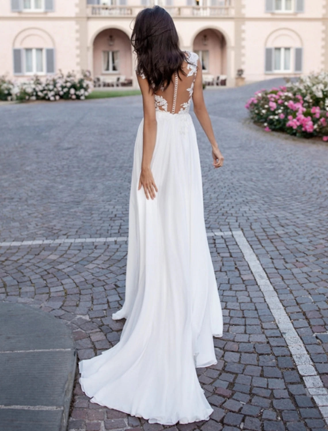 Back view of the A-line wedding dress showing open back and sweep train.