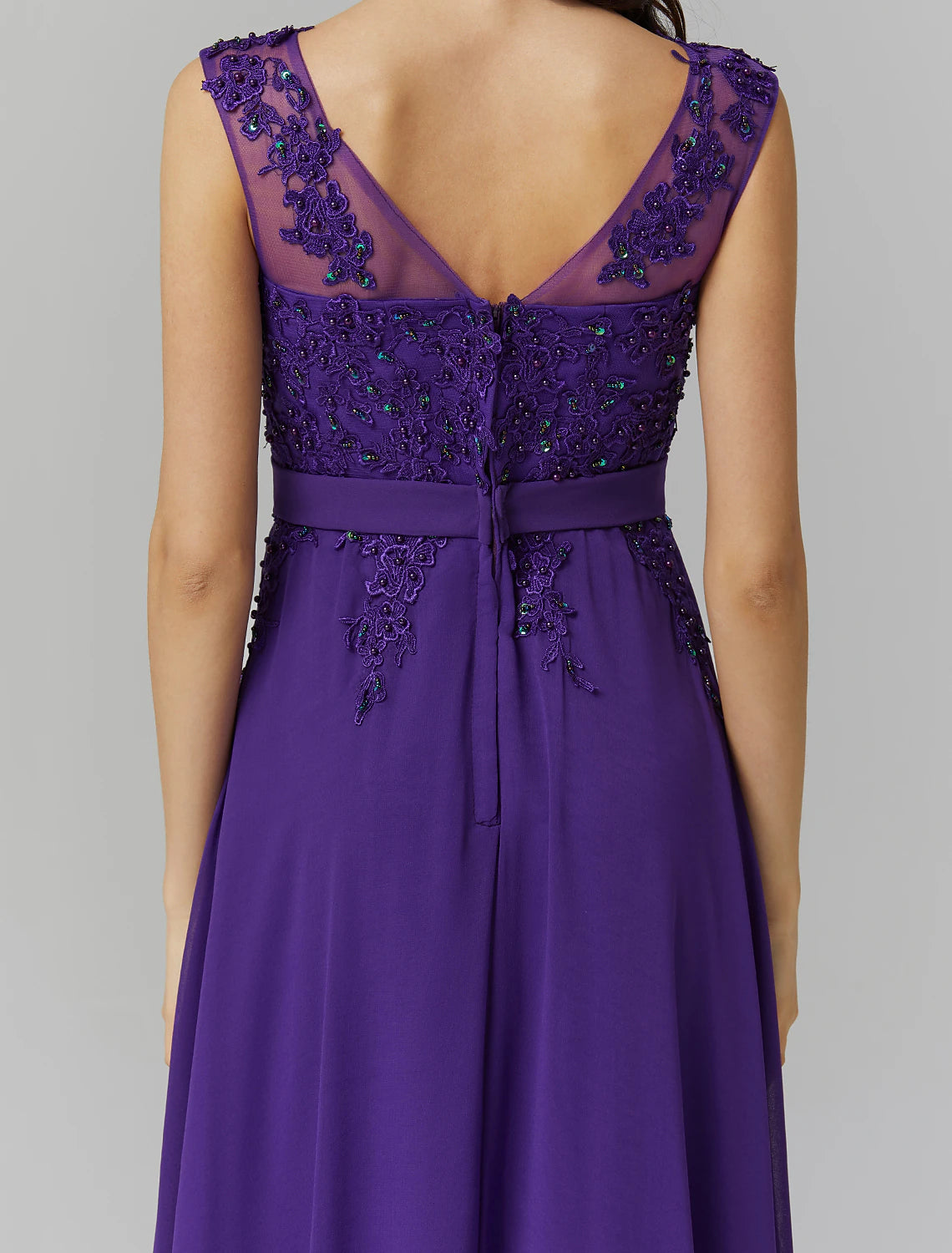 Side profile of a woman wearing a floor-length A-line evening gown.