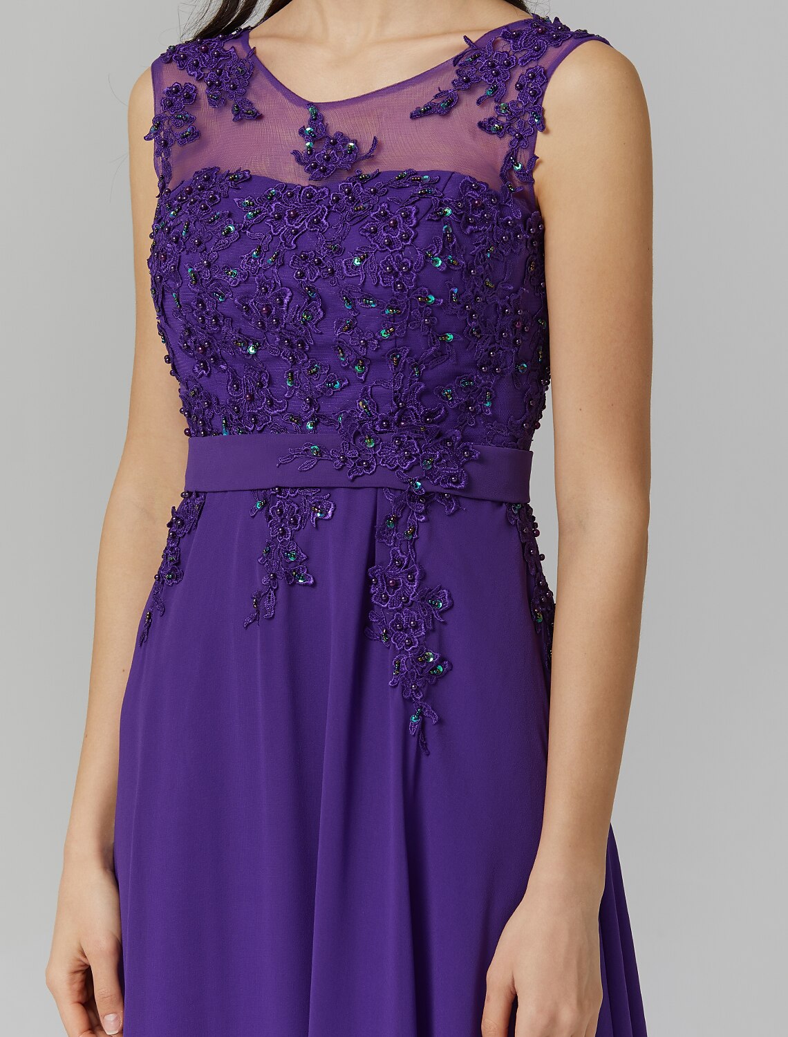 Close-up of the beaded appliques on the illusion neckline of the dress.
