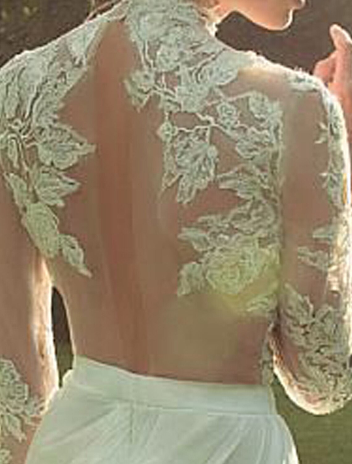 Close-up of the chiffon fabric and high neck detail on the wedding dress.