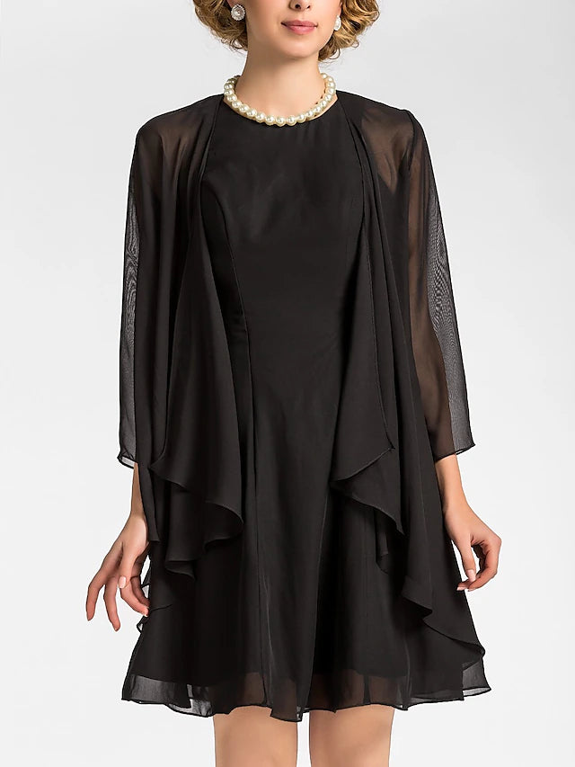 Close-up of the jewel neckline and 3/4 sleeve detail on the chiffon dress.