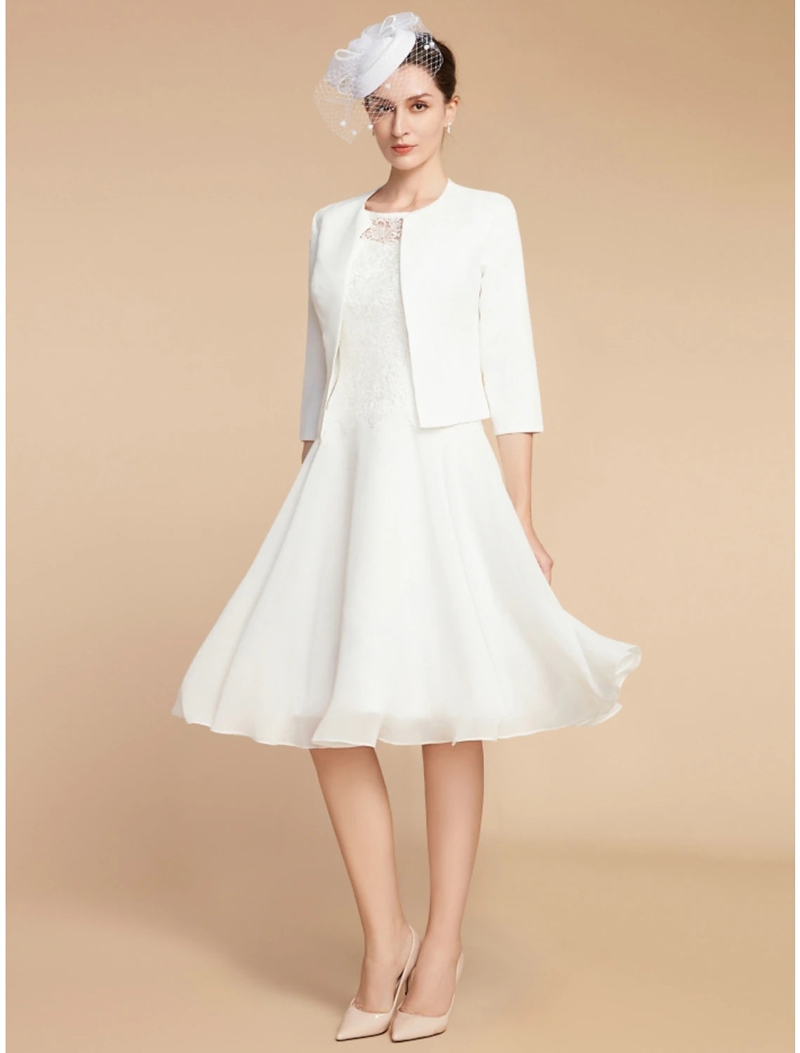 Full view of the knee-length dress, suitable for wedding guests.