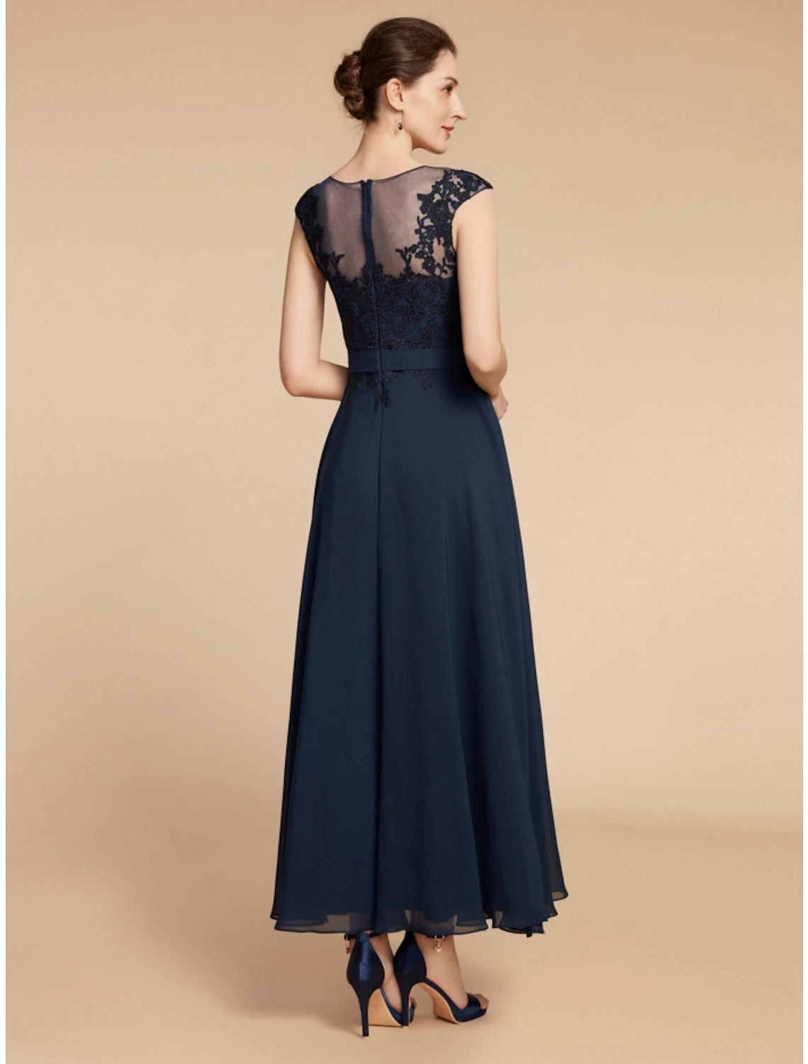 Close-up of the jewel neck and long sleeve details on the navy blue Mother of the Bride dress.