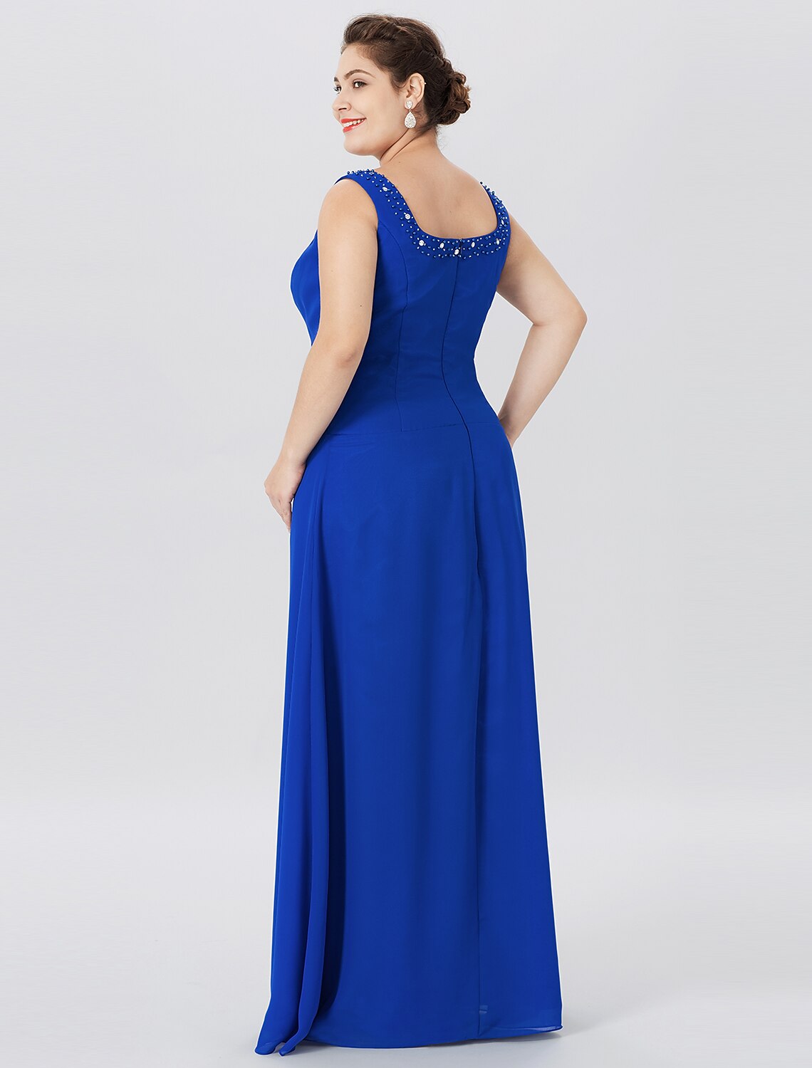 Close-up of the intricate lace and chiffon fabric on the dress.