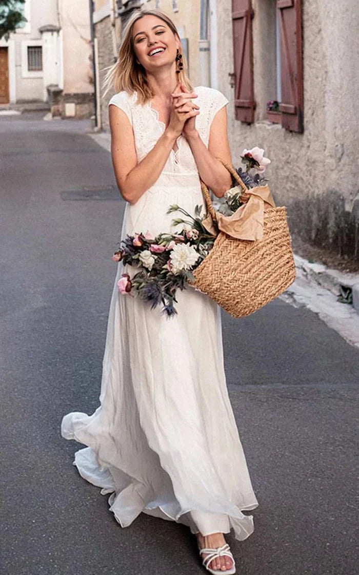 Elegant A-line chiffon wedding dress with lace V-neck and short sleeves.