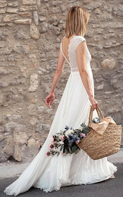 Back view of A-line wedding dress showing low-V back and flowing chiffon skirt.