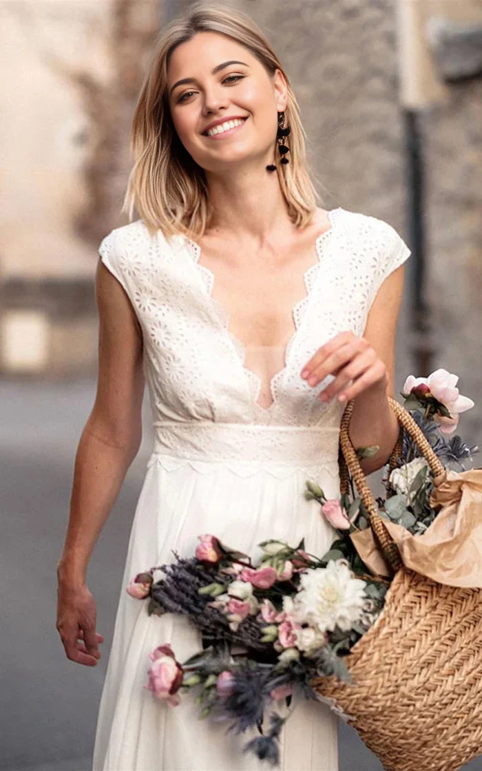 Close-up of the lace V-neck and short sleeves on a chiffon wedding dress.