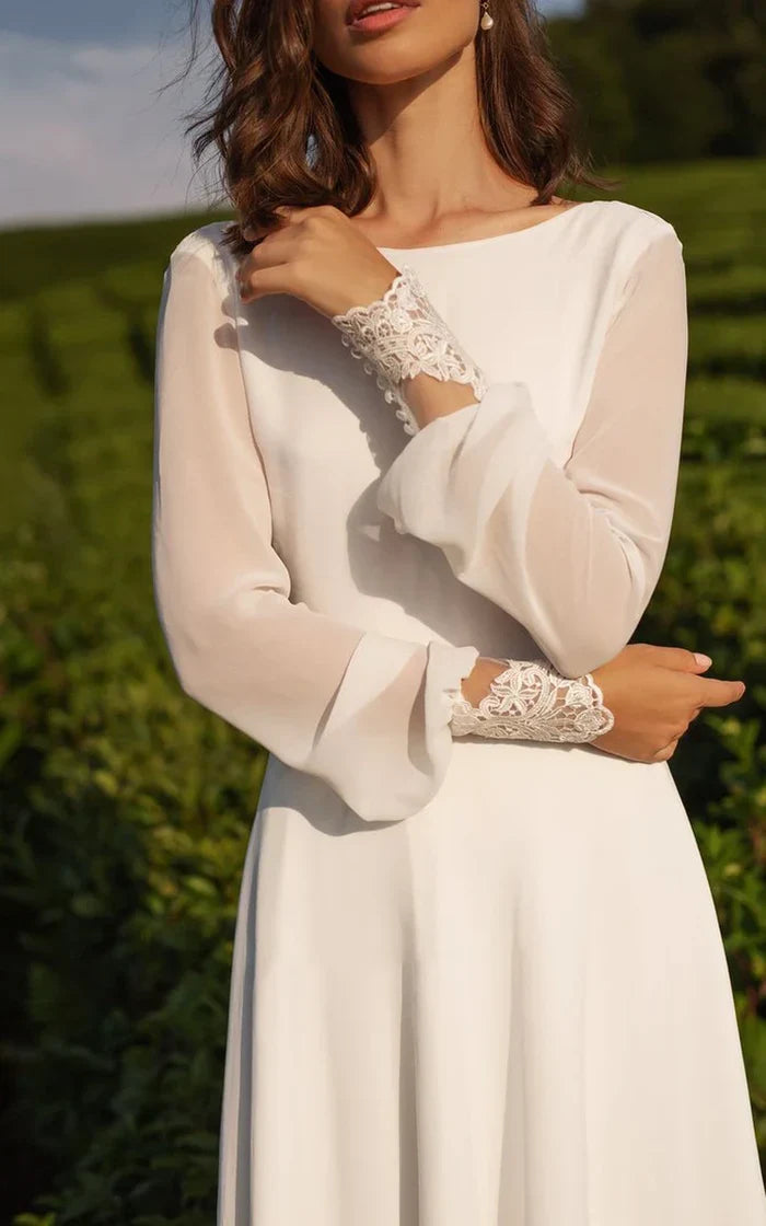 Back view of an A-line chiffon wedding dress showing the V-back and train.