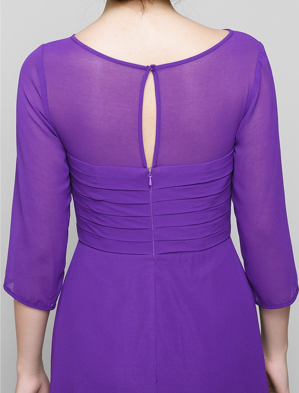 Detail of the ruched bodice and flowing chiffon skirt of the A-line dress.