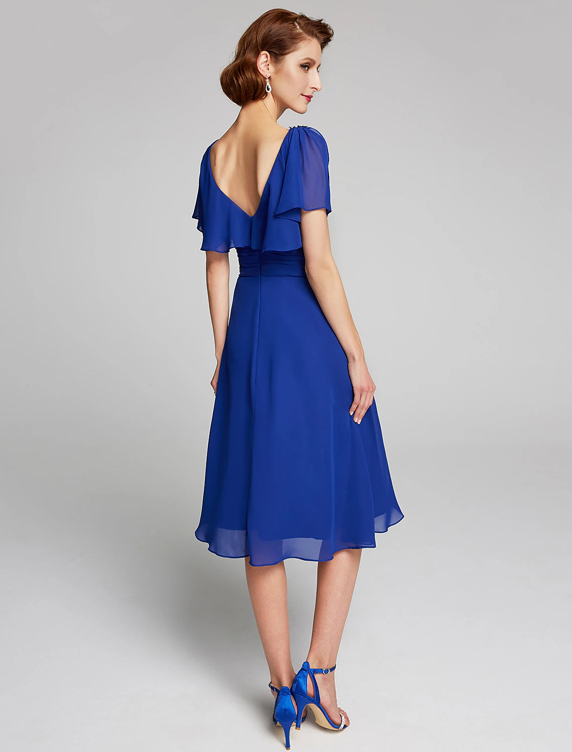 Side view of a knee-length chiffon A-Line dress with cowl neck.