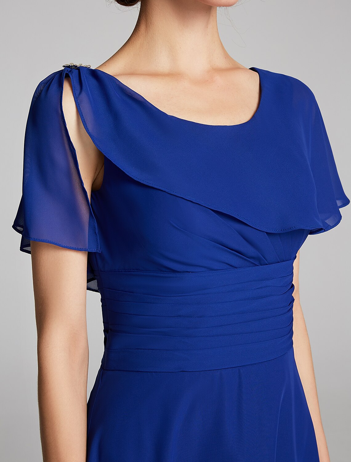 Close-up of the cowl neck and ruffled short sleeves on a chiffon dress.