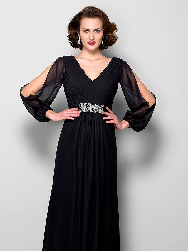 Close-up of the V-neckline and long sleeves on the chiffon gown.
