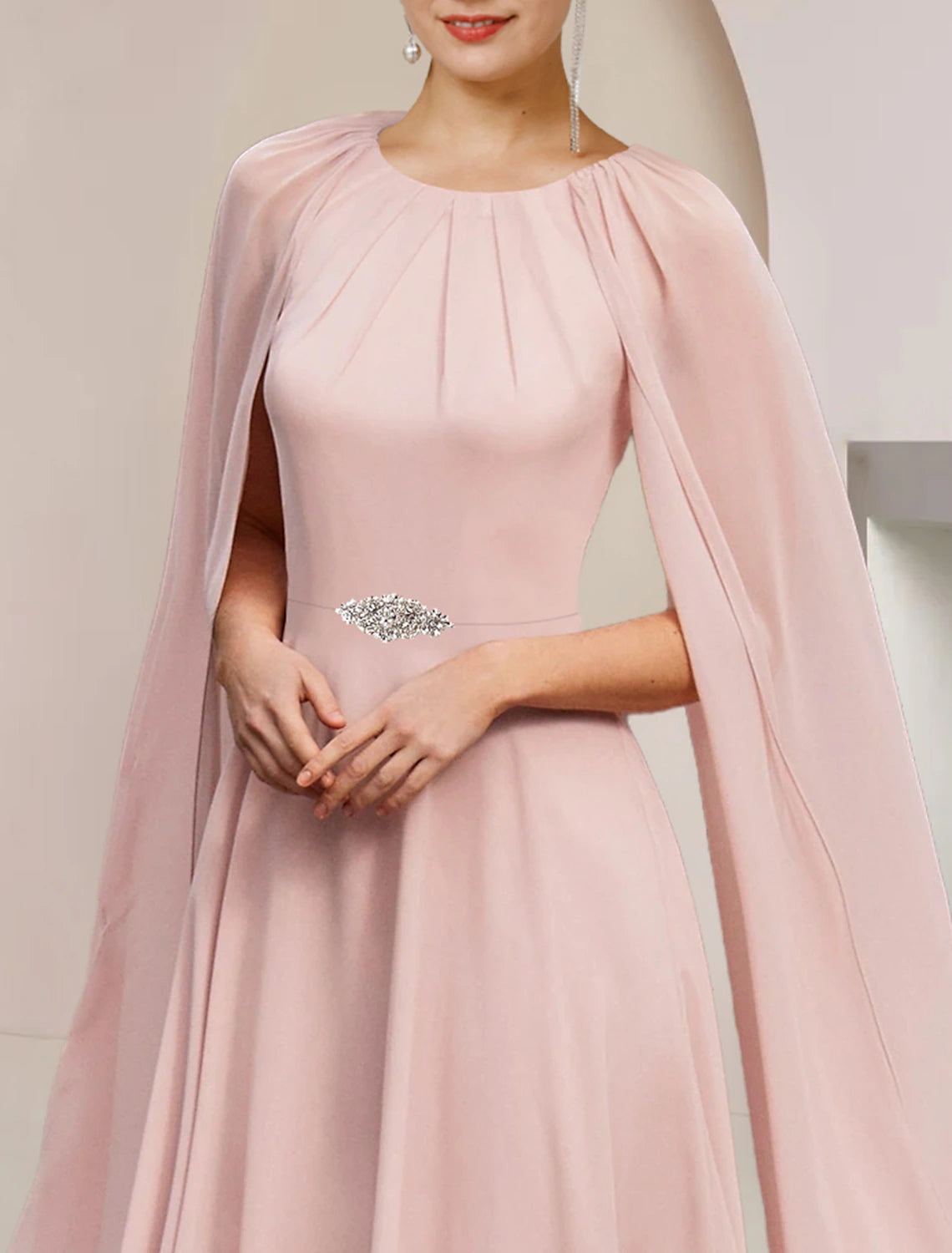 Back view of elegant A-line dress with scoop neck and crystal brooch.